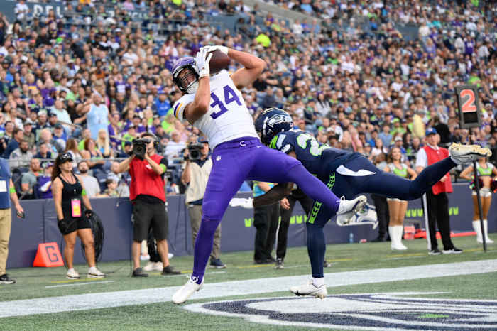 Aug 10, 2023; Seattle, Washington, USA; Minnesota Vikings tight end Nick Muse (34) catches a pass for a touchdown over Seattle Seahawks cornerback Tre Brown (22) during the first half at Lumen Field.